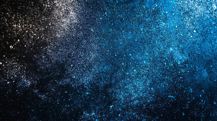 Obraz premium Abstract cosmic effect created by blue and white powder on a black background in an image