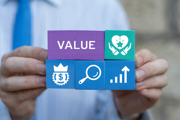 Business man holding colorful blocks sees word: VALUE. Increase value, growth value service,...