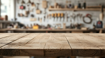 Equipment workshop background concept. A rustic wooden table foreground with a blurred workshop background filled with tools, creating a cozy crafting atmosphere.