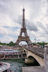 Obraz premium Eiffel Tower and Pont d'Iena, Paris, France. Tourists and cruises over the Seine. Group of tourists, sunny day.