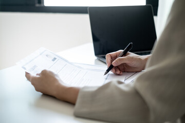 Executive CEO businesswoman checking job applicant documents resumes, interviews, and signing to approve the contract in the office room