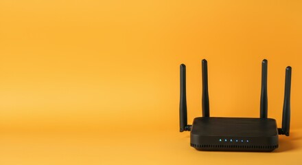 Fototapeta premium Black wireless router with four antennas against orange background
