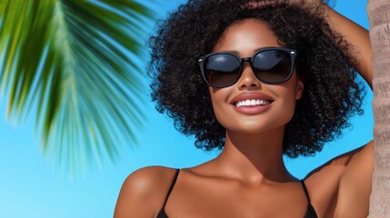Fototapeta premium Radiant summer vibes: smiling woman in sunglasses under palm tree with blue sky