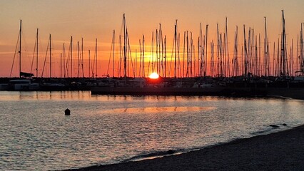 Sunset with sailing boats on the background