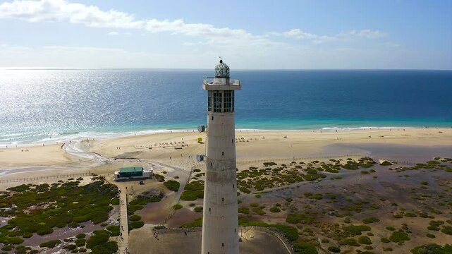 Aerial view of the beautiful lighthouse of Morro Jable, with low tide, in the Atlantic island of Fuerteventura, Spain.
