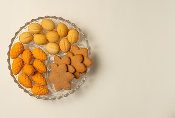 Plate with cookies on beige background. Flat lay, top view. Copy space