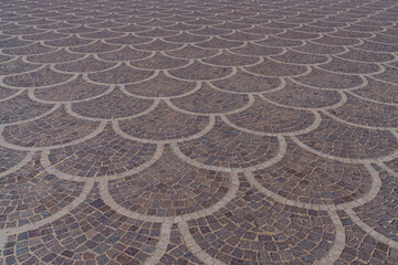 Beautifully and symmetrically arranged paving stones on a large square