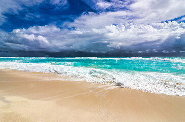Storm clouds during the hurricane season present a dark sky over the turquoise blue waters and the beautiful Playa Delfines beach in the hotel zone of Cancun,Quintana Roo,Mexico 