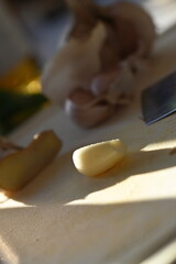 A light background featuring a cutting board with a kitchen knife and garlic, creating a scene of meal preparation. The image highlights the essential elements of cooking and recipe preparation