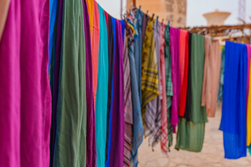 Drying, hanging colored materials in a desert environment.