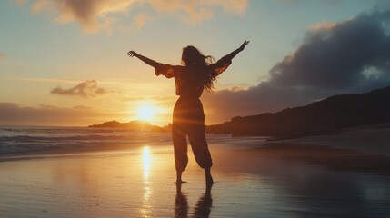 Fototapeta premium Woman silhouetted at sunset beach, arms outstretched.