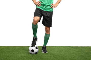 Football player with soccer ball on artificial grass against white background, closeup