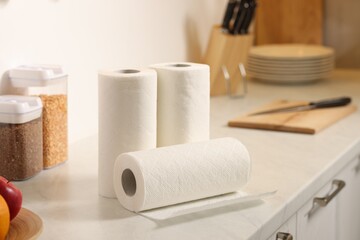 Rolls of paper towels on white marble countertop in kitchen