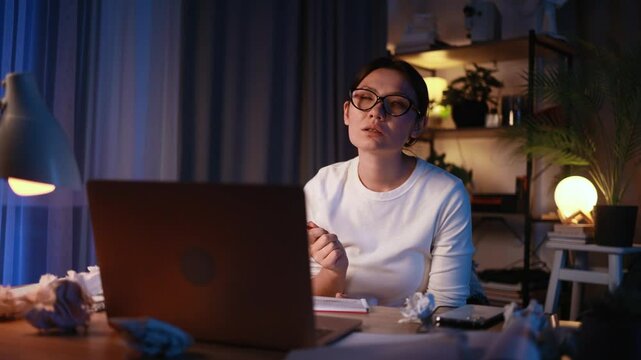 Portrait of beautiful young asian woman thinks questioningly about difficult choice choose imagine plan in mind has doubts late at night at home workplace