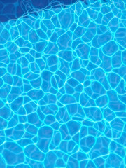 Obraz premium Close-up of ripples on the blue surface of a swimming pool, splash marks, reflective surface, calm water, fluid dynamics, wave patterns