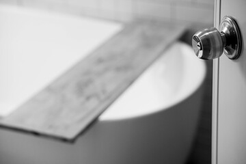 focus Bathroom door handles of Modern bath room with wooden shelf on bath empty and white interior design