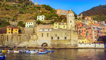 Vernazza, one of Italy's enchanting Cinque Terre villages, captivates with its colorful cliffside houses, quaint harbor, and stunning views of the Ligurian Sea.