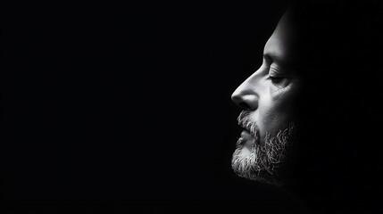 Man's Profile in Dramatic Black and White Lighting