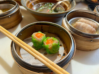 Delicious chinese dim sum on wooden plate 
