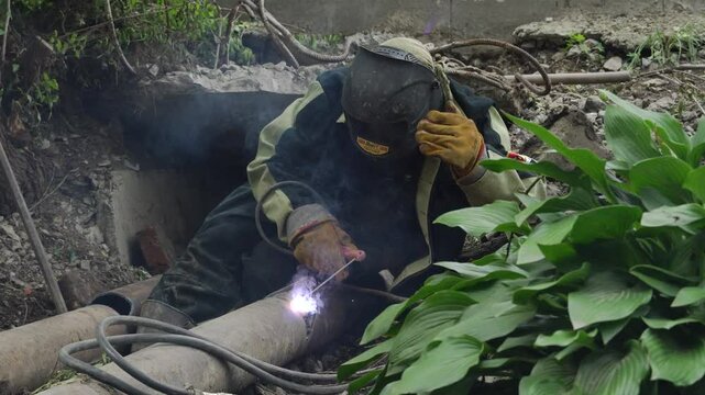 August 13, 2020 - Artem, Russia - Heating main repair. Workers are repairing the heating main.