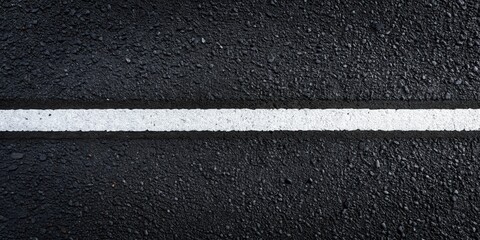 Fototapeta premium High-resolution close-up image showing a single, horizontal white line painted on a dark asphalt surface.
