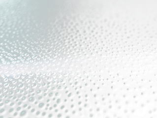 Close-up of water droplets on a dark surface.