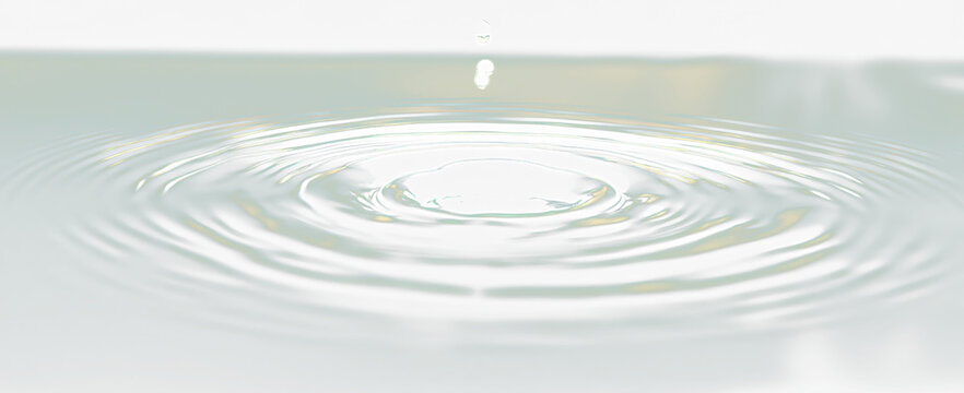 Water droplet impact creating concentric ripples on a dark teal surface.