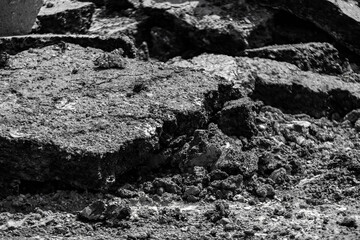 Natural black coal pile. Photograph of damaged asphalt road surface. Road maintenance. Stone. Transportation and communication. black asphalt texture. asphalt road. stone asphalt.