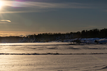 Gamla Uppsala, Sweden An icy land winter landscape at sunset close to the Royal Mounds.