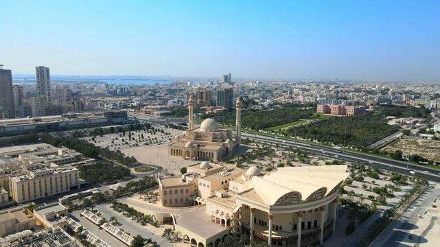 Camera drone flies ahead above the Isa Cultural Centre, Al Fateh Grand Mosque, and Al-Qudaibiya Palace, Manama, Bahrain