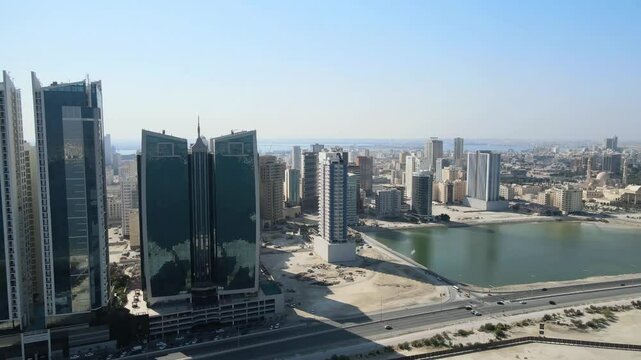 A camera drone flies by high-rise apartment complexes and hotels in Alfateh District of Manama, Bahrain