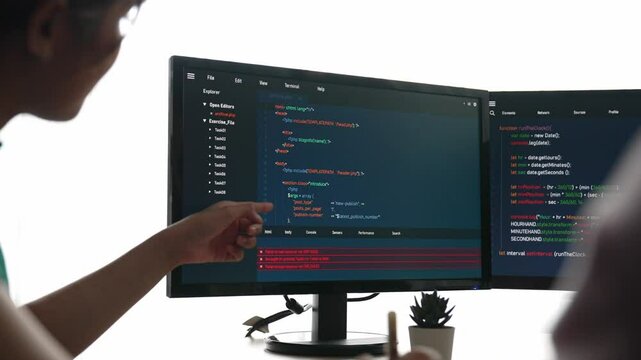 Back end software developer engineer for computer programming working together on debugging writing computing code, solving complex algorithms display on monitor in office. Burgeoning