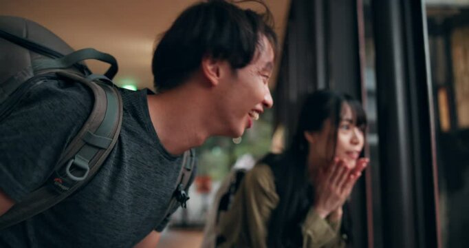 Travel, excited and people pointing in zoo for experience, sightseeing and fun in Japan. Happy couple, outing and gesture in Japanese monkey park for vacation, holiday and relationship development