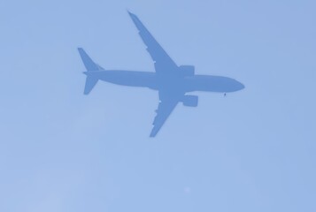 _ - A faint, moving shadow cast by an airplane high in the sky,