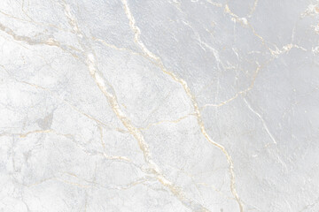 Close-up of black marble with white and gold veins.
