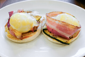 Eggs benedict with bacon on English muffins