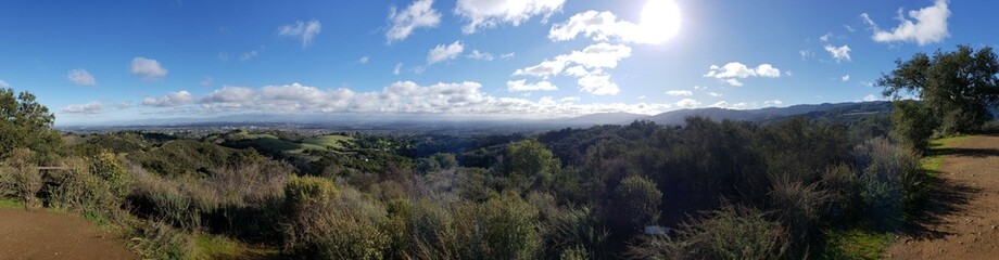 Panoramic View of Rolling Hills and Cityscape