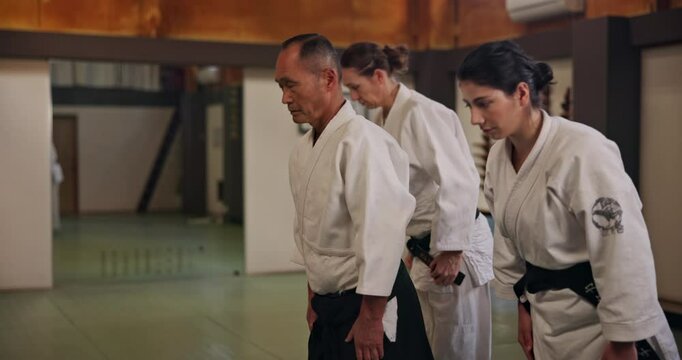 Class, people or bow in dojo for learning karate, discipline or self defense for coaching. Respect, mature sensei or students in Japan for teaching combat or training for fighting education or honor