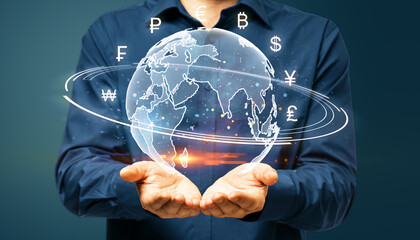 Man holding digital globe with international currency symbols in his hands on dark background, concept of global finance.