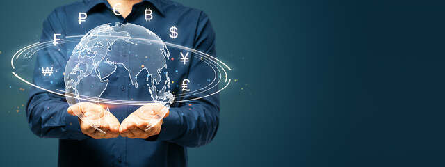 Businessman holding digital globe with currency symbols floating around. Concept of global finance...