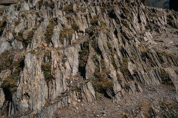 A rock formation. The mountain in the section. The stone pattern. The texture of a mountain stone