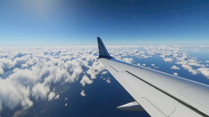 Aerial View from Airplane Wing Over Clouds and Ocean Landscape