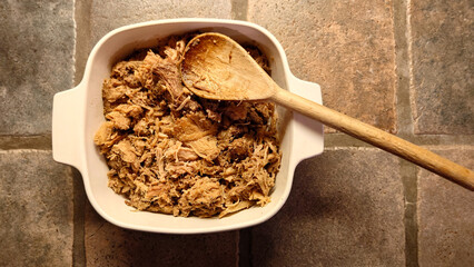 pork carnitas (carnitas de cerdo) made from shredded pork shoulder in microwave capable casserole...