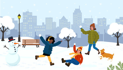 Fun winter day in the park with friends playing in the snow and building a snowman