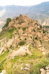 Dagestan Gamsutl. Ancient ghost town of Gamsutl old stone houses in abandoned Gamsutl mountain village in Dagestan, Abandoned etnic aul, summer landscape.