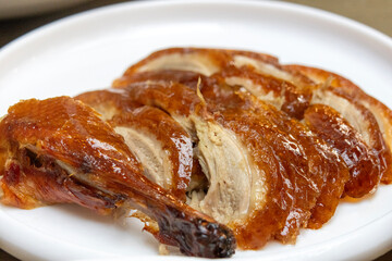 Chinese cook prepares Peking Roast Duck.