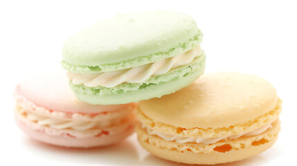 Fototapeta premium Colorful macarons stacked on each other showcasing pastel colors of pink, green, and yellow with creamy filling, perfect for dessert or pastry-themed projects.