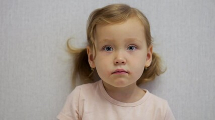 Little girl displaying symptoms of chickenpox with red spots on her face