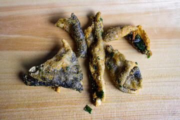 Salted egg yolk fish skin snacks on a wooden board