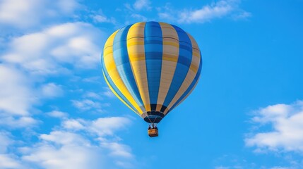 Fototapeta premium Colorful Hot Air Balloon Floating in a Bright Blue Sky with Fluffy Clouds, Perfect for Adventure, Travel, and Outdoor Activities Photography Needs